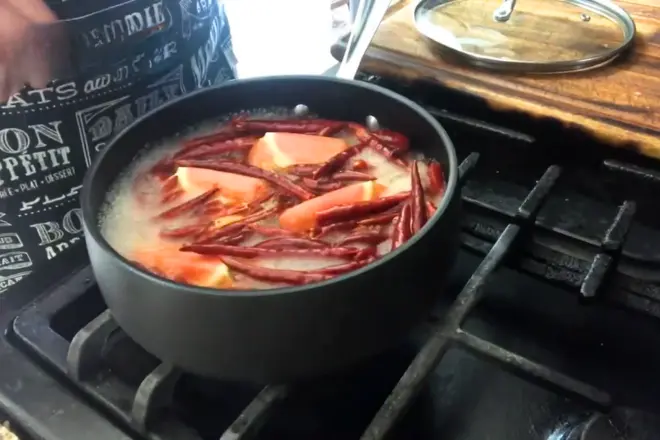 Boil the chilies and tomato